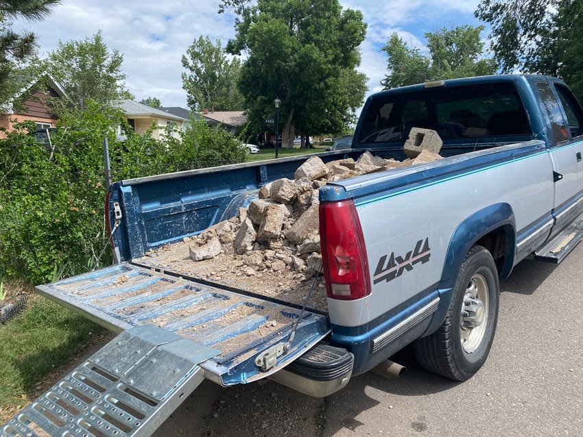 Pieces of Virginia Keller's old front walkway were removed by volunteers on June 18, 2022, and placed in the back of a truck.
